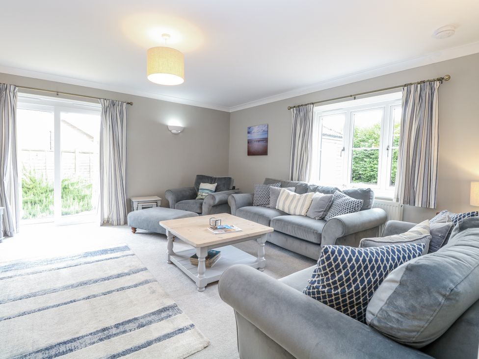 A living room with a coffee table and sofas at Woodlark