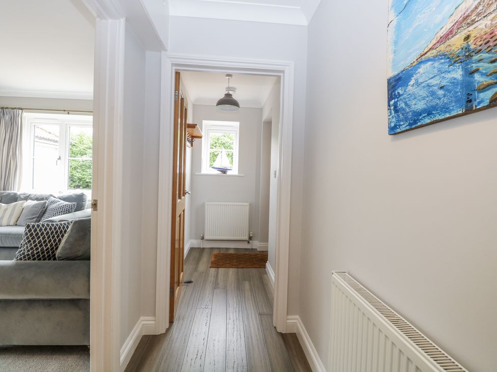 A hallway with a couch and windows at Woodlark