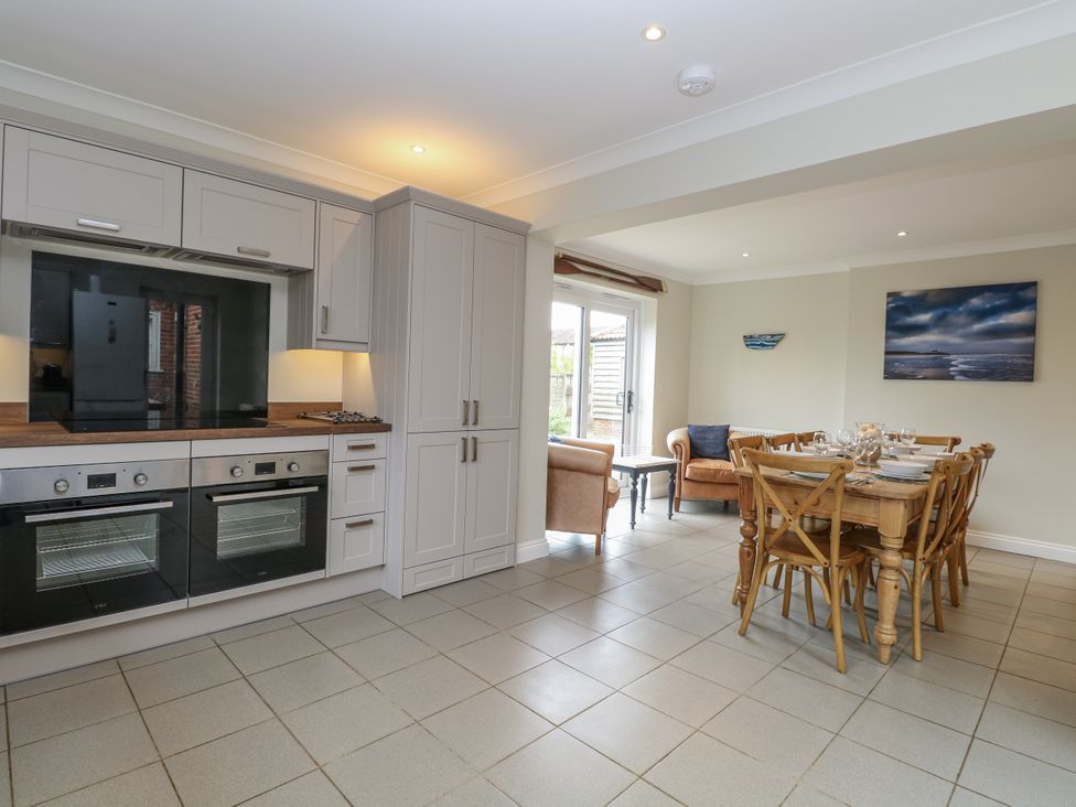 A kitchen with an oven and dining table at Woodlark