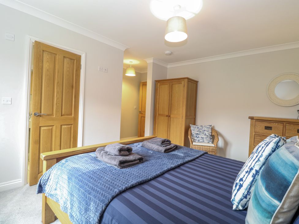 A bedroom with a bed and wardrobe at Woodlark