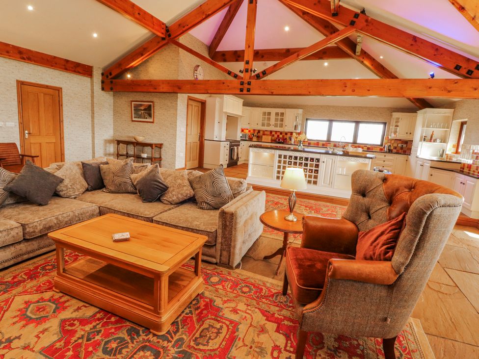 A living room with a sofa and coffee table at Old Riggs Paddock in Penrith