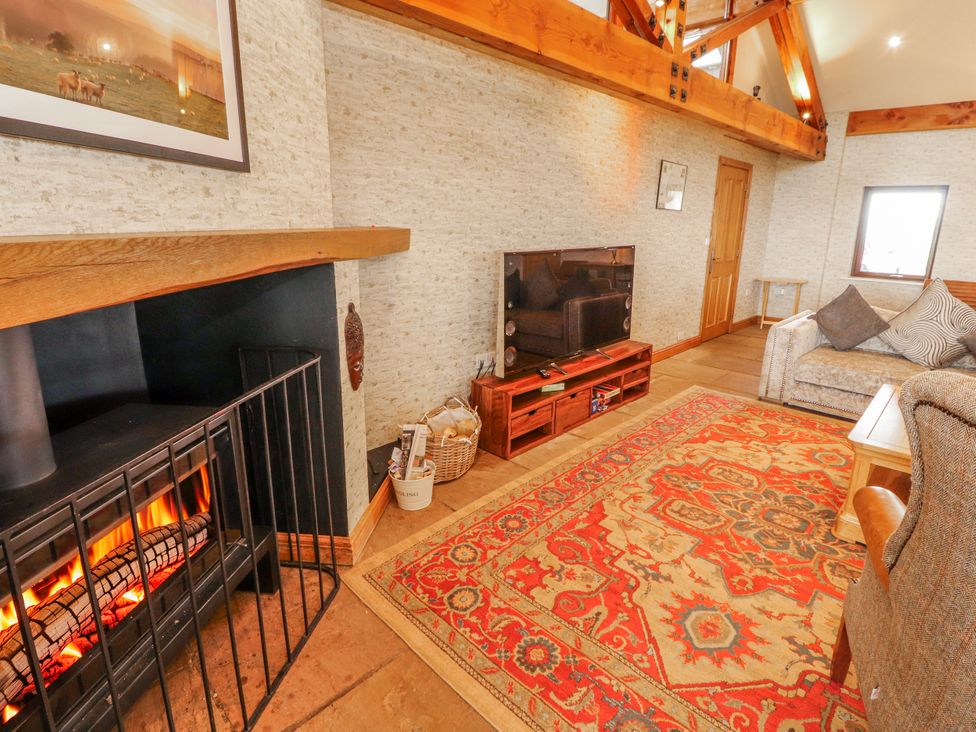 A living room featuring a fireplace and a tv at Old Riggs Paddock in Penrith