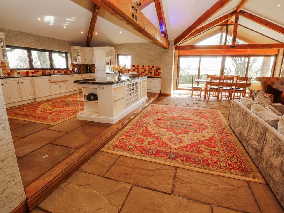 A kitchen with dining area and sofa at Old Riggs Paddock in Penrith