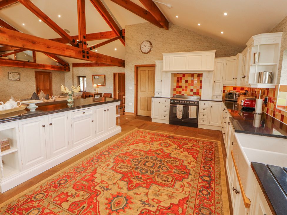 A kitchen with a rug and cabinets at Old Riggs Paddock Penrith