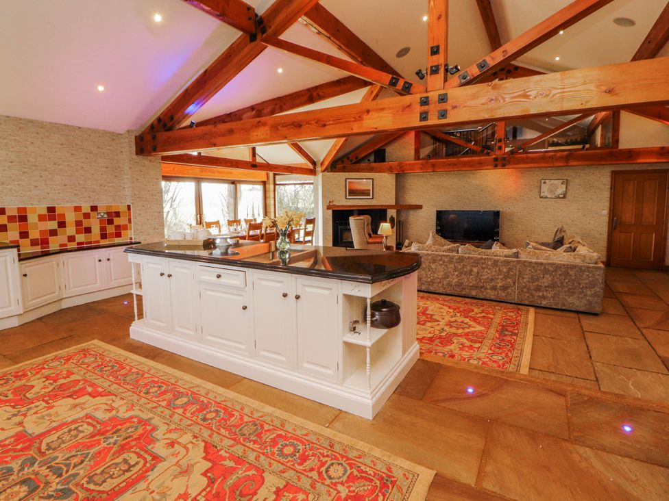 A kitchen with an island and a dining table at Old Riggs Paddock in Penrith