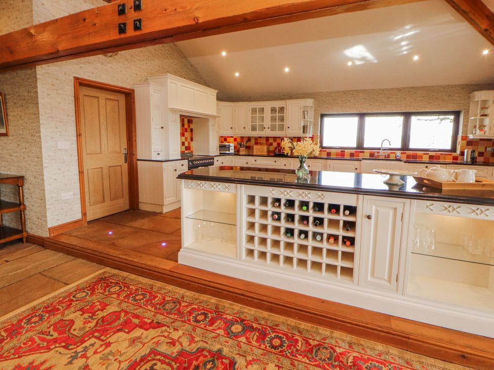 A kitchen with wine rack and cabinets at Old Riggs Paddock in Penrith