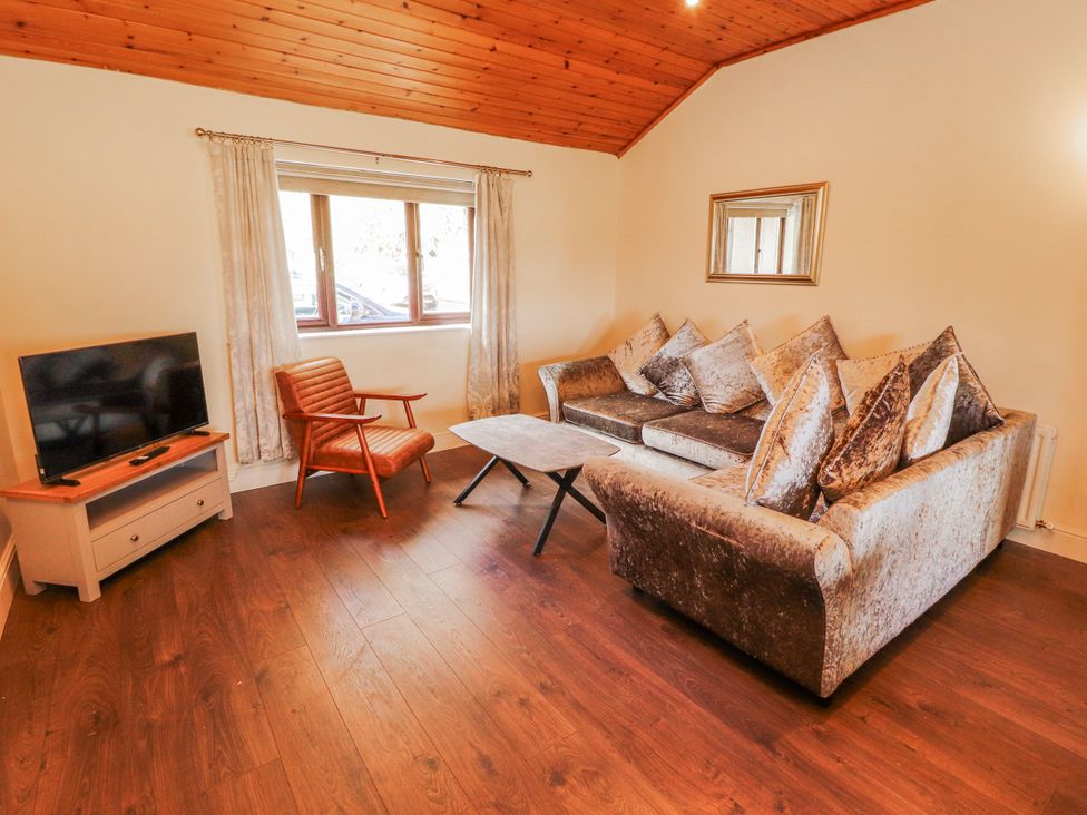A living room with a sofa and television at Old Riggs Paddock in Penrith