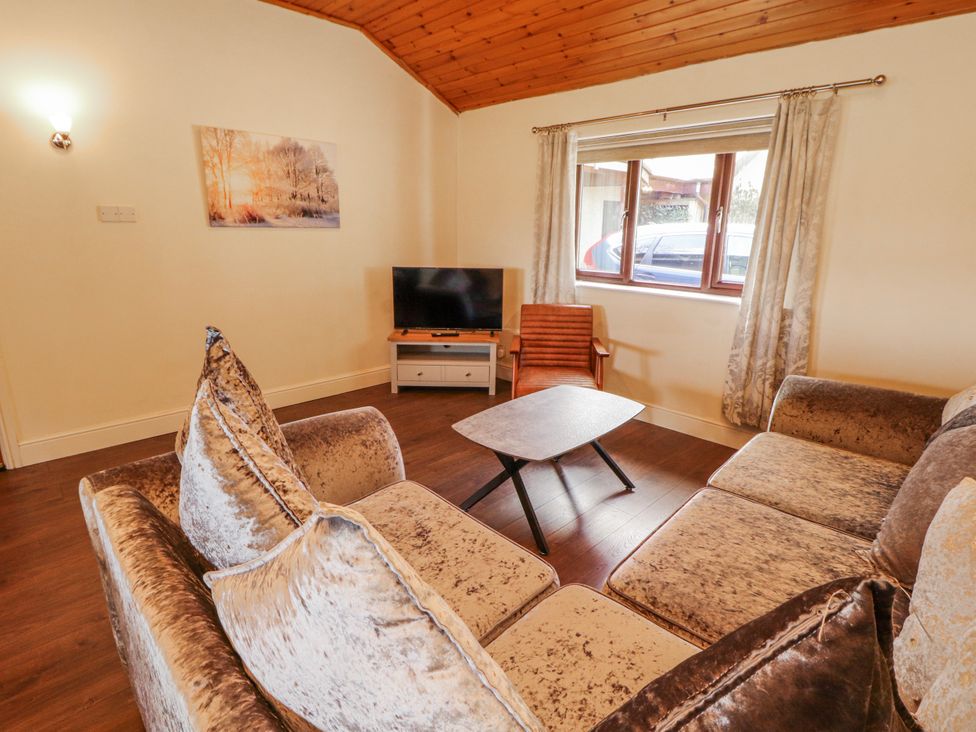 A living room with a sofa and television at Old Riggs Paddock in Penrith