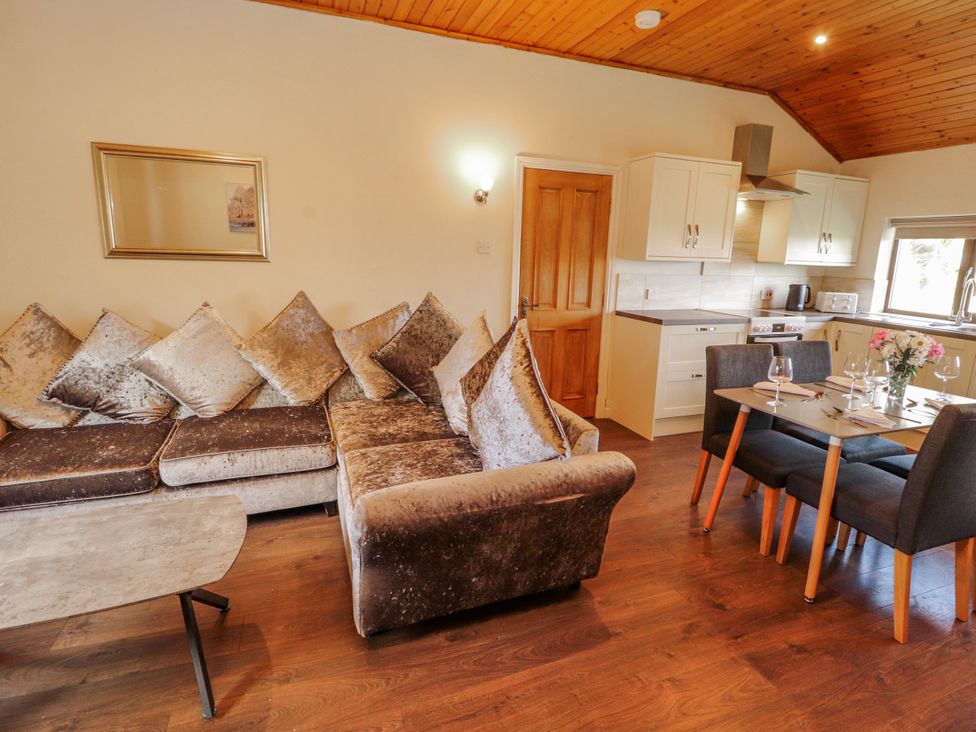 A living room with a sofa and dining table at Old Riggs Paddock in Penrith