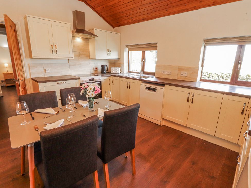 A kitchen with a dining table and chairs at Old Riggs Paddock in Penrith