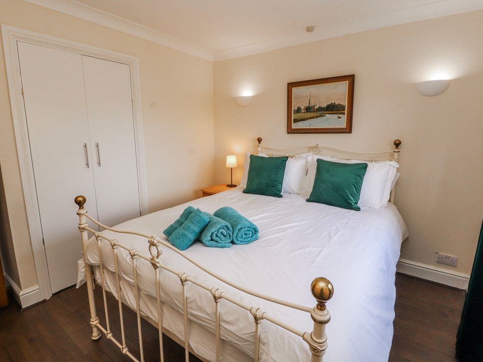 A bedroom with a double bed and towels at Old Riggs Paddock in Penrith