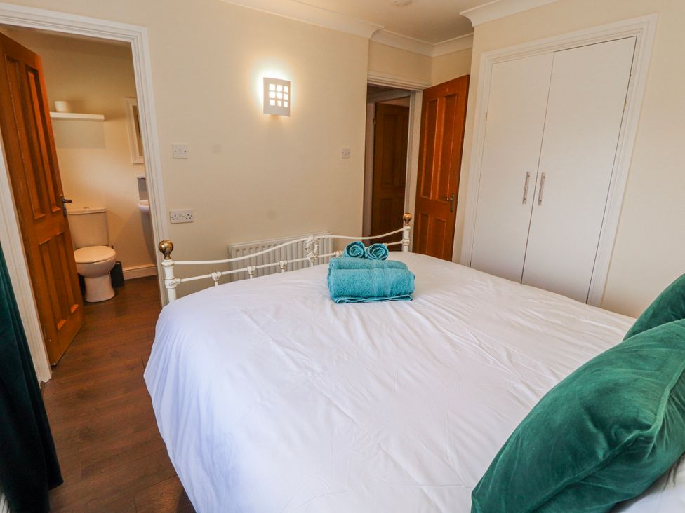 A bedroom with a bed and bathroom door at Old Riggs Paddock in Penrith