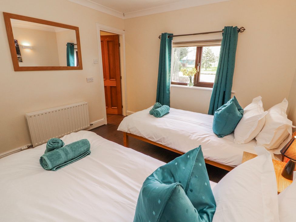 A bedroom with two beds and towels at Old Riggs Paddock in Penrith