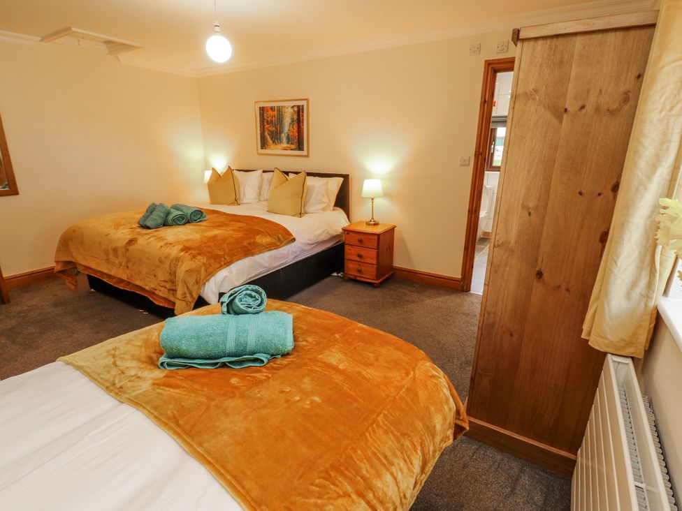 A bedroom with two beds and a bedside table at Old Riggs Paddock in Penrith