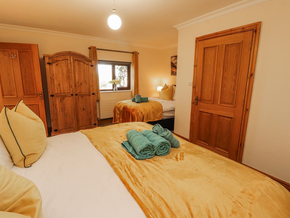 A bedroom with two beds and a wardrobe at Old Riggs Paddock in Penrith