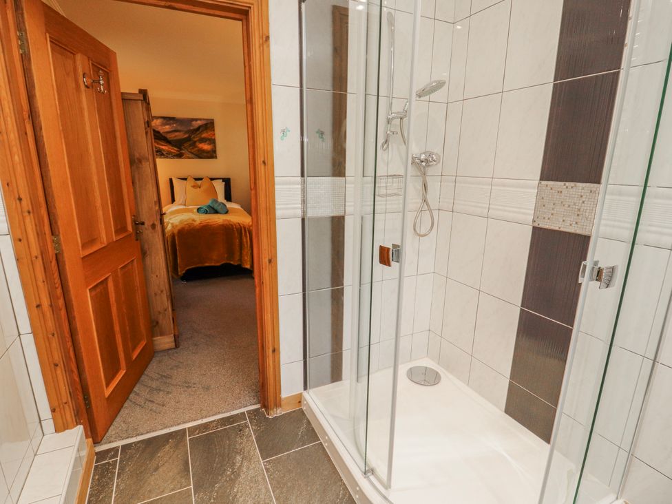 A bathroom with a shower and a view into a bedroom at Old Riggs Paddock in Penrith