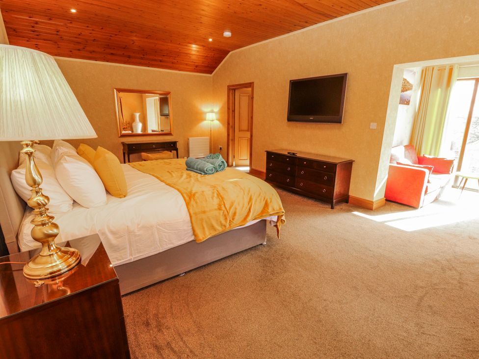 A bedroom with a bed and television at Old Riggs Paddock in Penrith