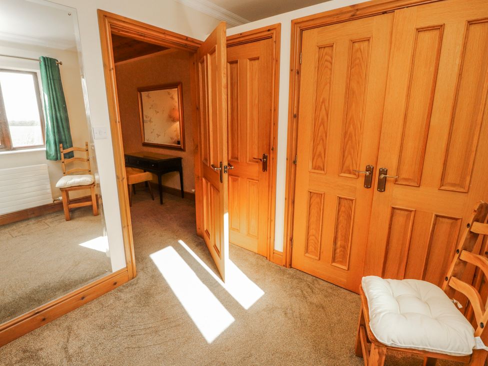 A bedroom with doors and a mirror at Old Riggs Paddock in Penrith