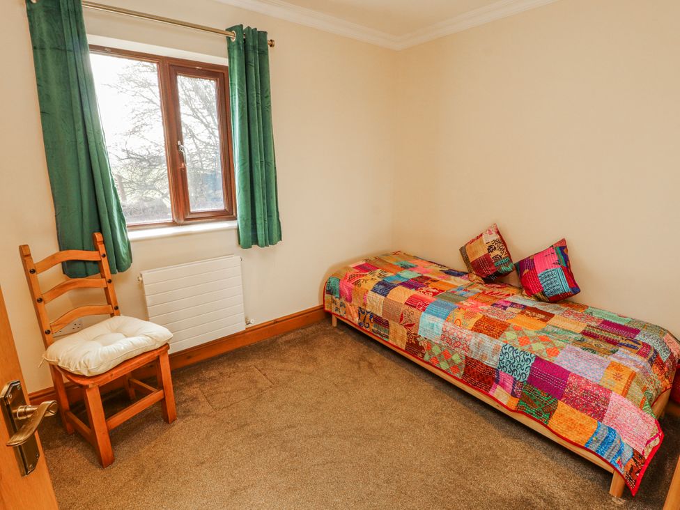 A bedroom with a bed and a chair at Old Riggs Paddock in Penrith
