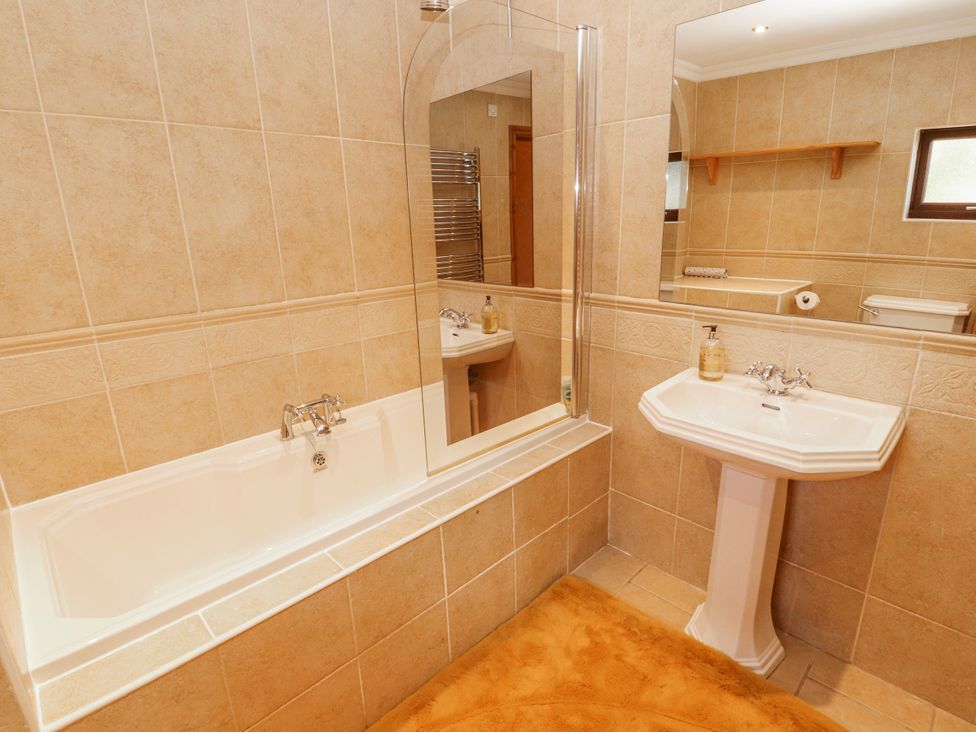 A bathroom with a bathtub and sink at Old Riggs Paddock in Penrith