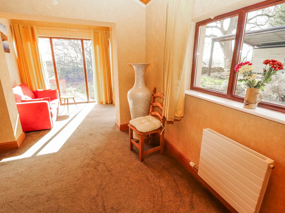 A living room with a sofa and side table at Old Riggs Paddock Penrith