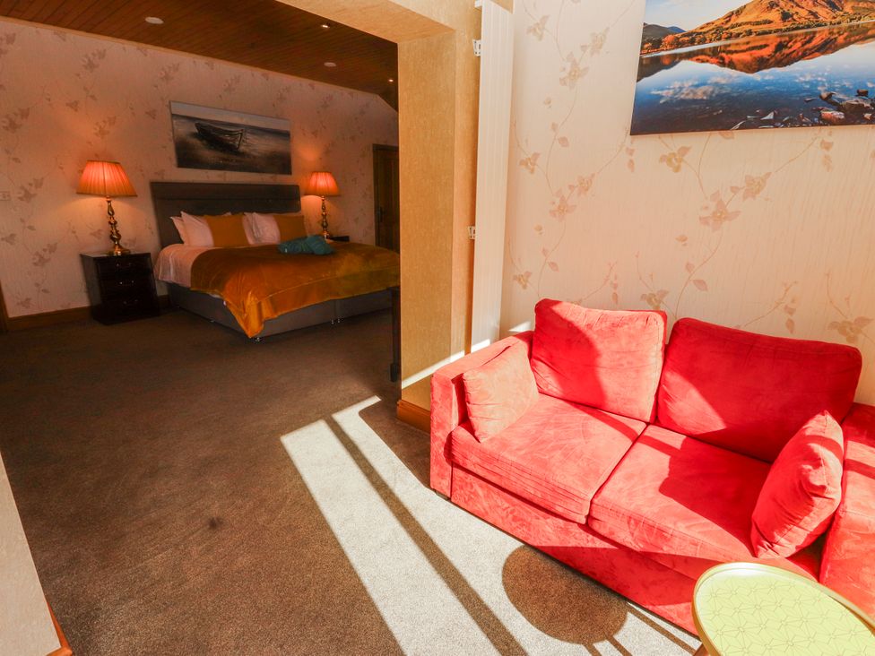 A bedroom with a bed and couch at Old Riggs Paddock in Penrith