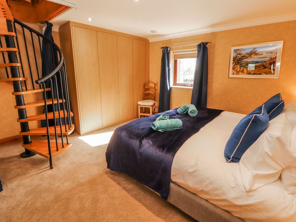 A bedroom with a bed and a staircase at Old Riggs Paddock in Penrith