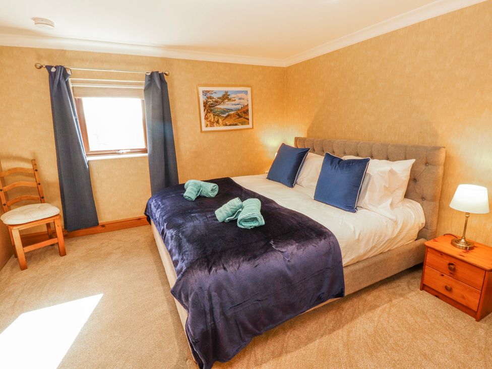 A bedroom with a bed and chair at Old Riggs Paddock Penrith