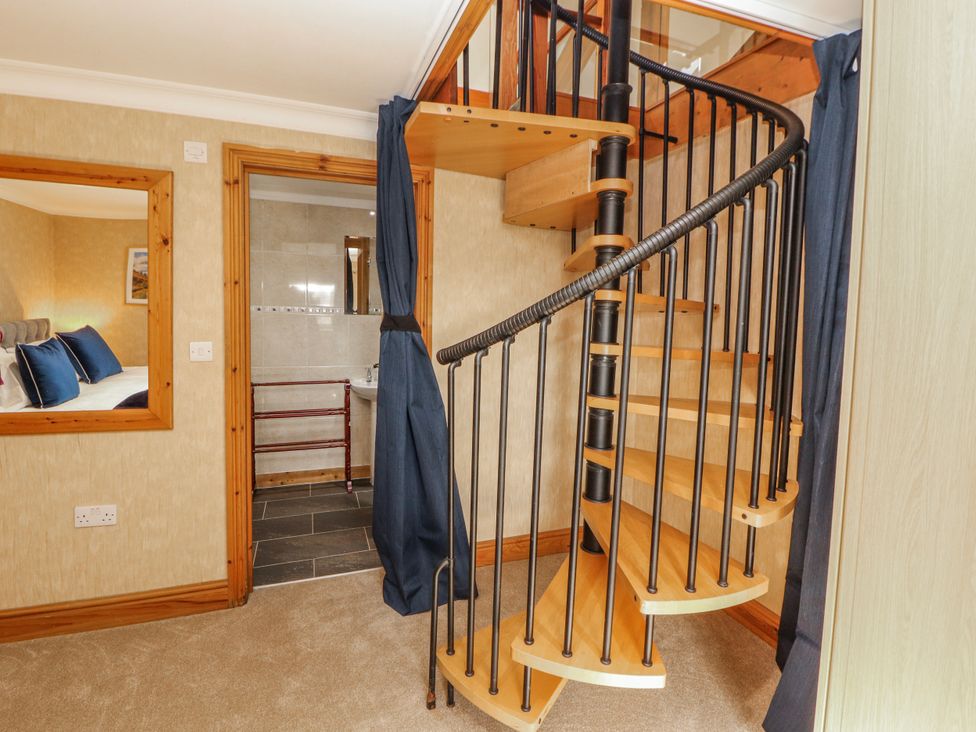 A staircase with a spiral design at Old Riggs Paddock in Penrith