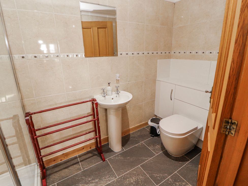 A bathroom with a sink, toilet, and mirror at Old Riggs Paddock in Penrith