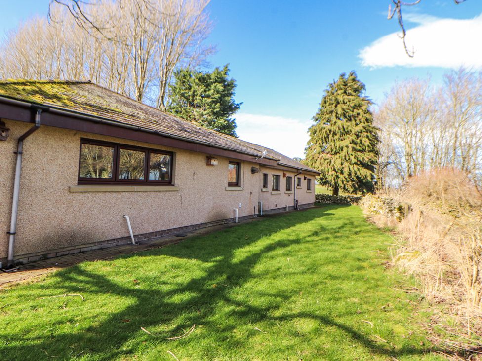 A side view of a house with grass and trees at Old Riggs Paddock in Penrith