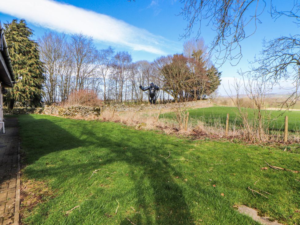 A garden area with a sculpture and trees at Old Riggs Paddock Penrith