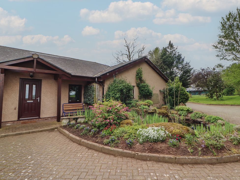 An outdoor area with a garden and a bench at Old Riggs Paddock near Penrith