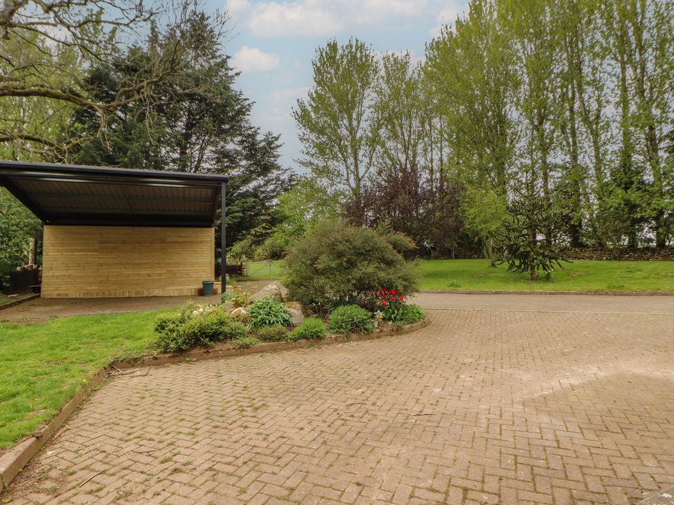 A garden with a carport and flower bed at Old Riggs Paddock near Penrith