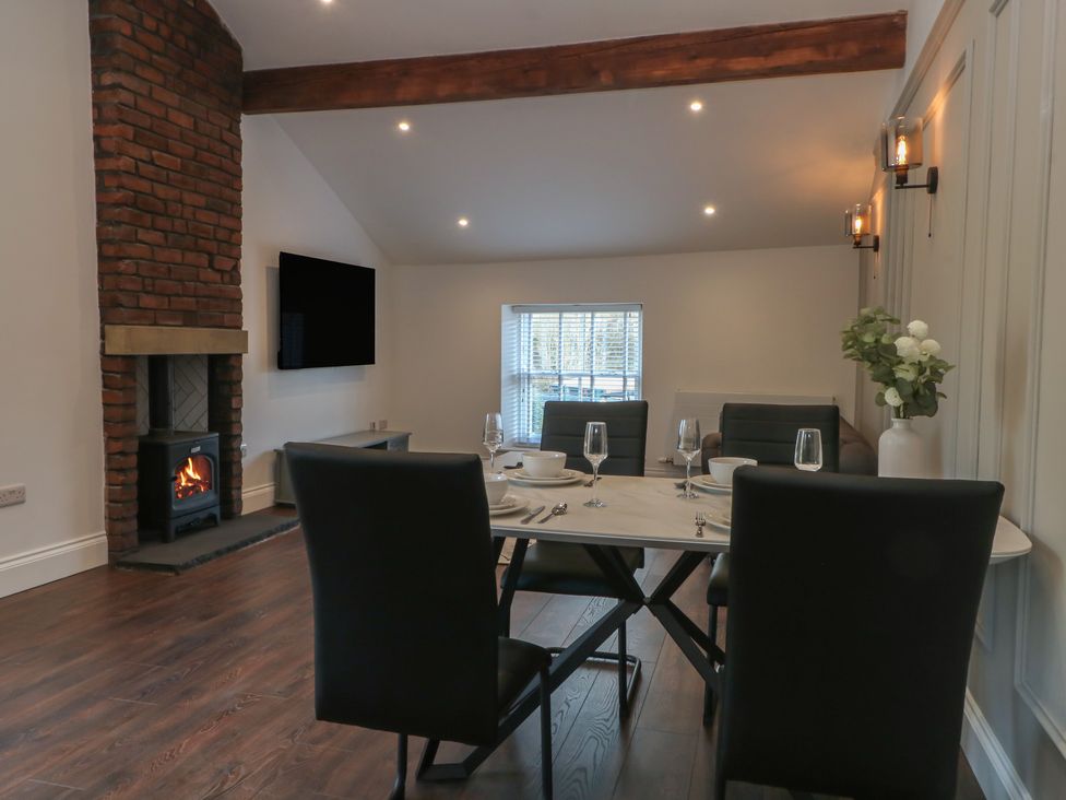 A dining room with a table and chairs at The Penthouse at 86 Rossendale
