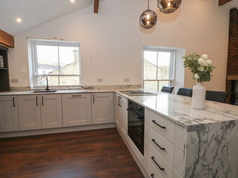 A kitchen with cabinets and countertops at The Penthouse at 86 Rossendale