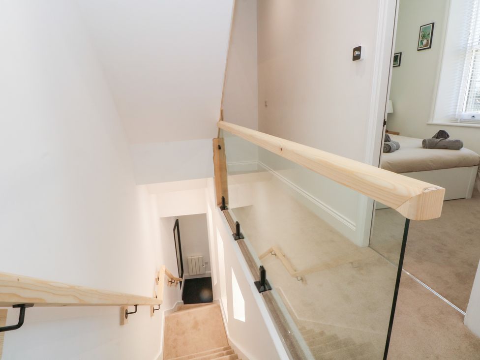 A staircase leading to a door at The Penthouse at 86 Rossendale