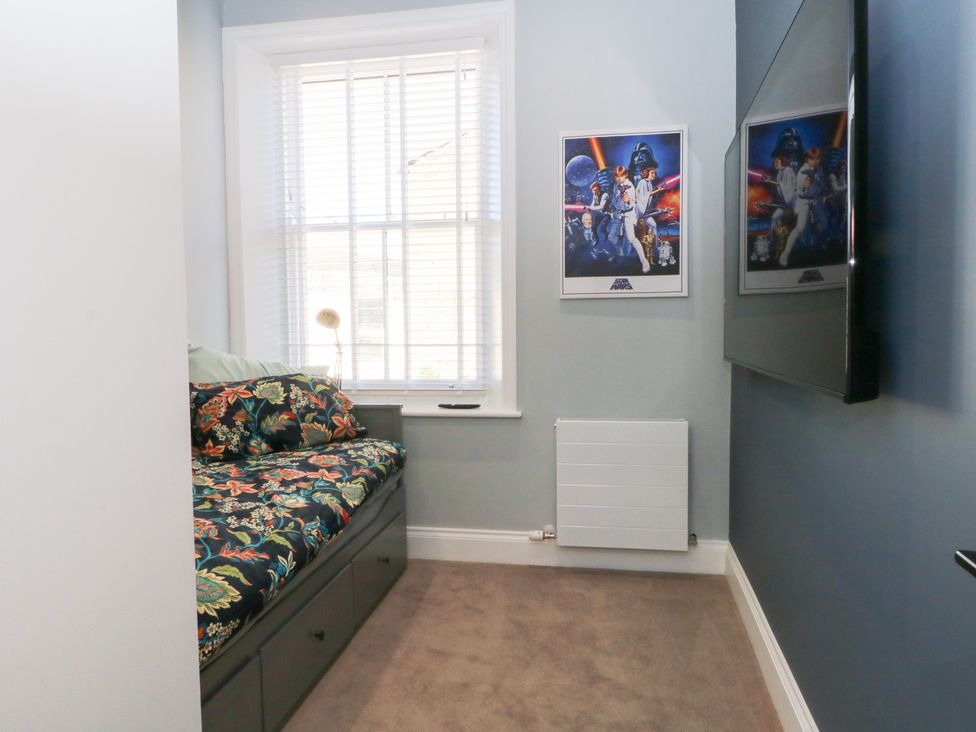 A bedroom with bedding and posters at The Penthouse at 86 Rossendale