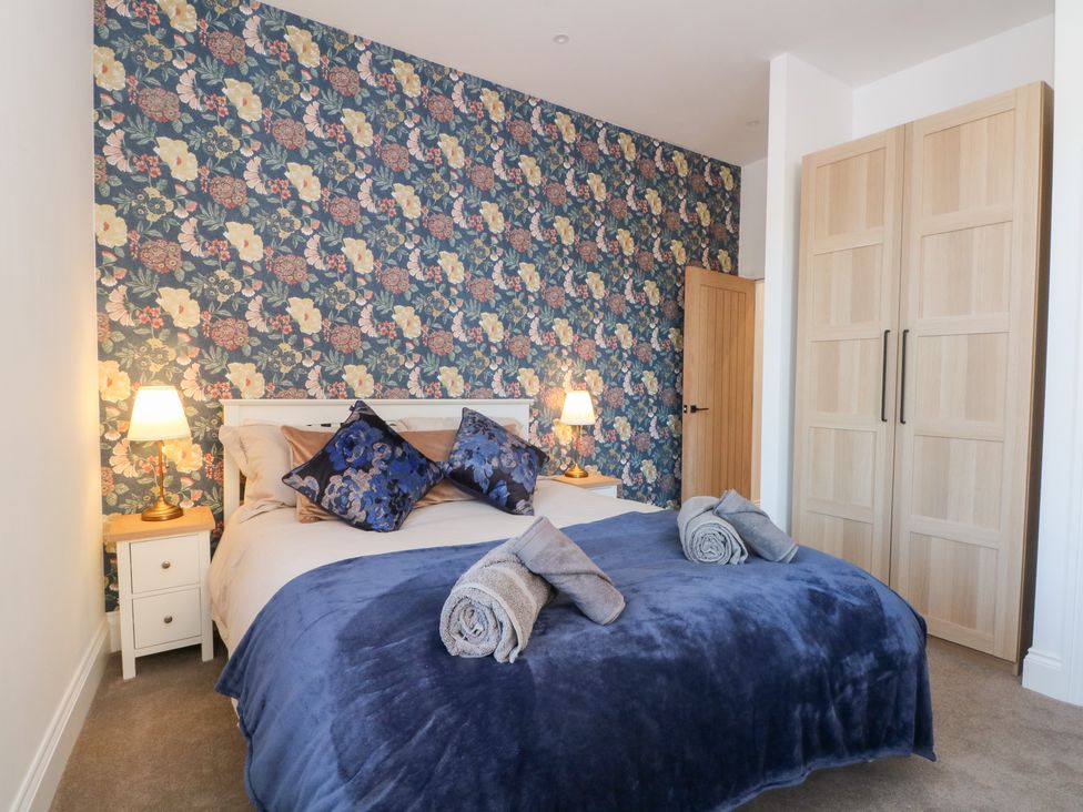 A bedroom with a bed and wardrobe at The Penthouse at 86 Rossendale