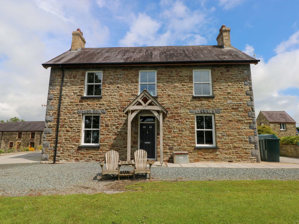 A house with chairs in front at The Sycamores in Llawhaden near Narberth