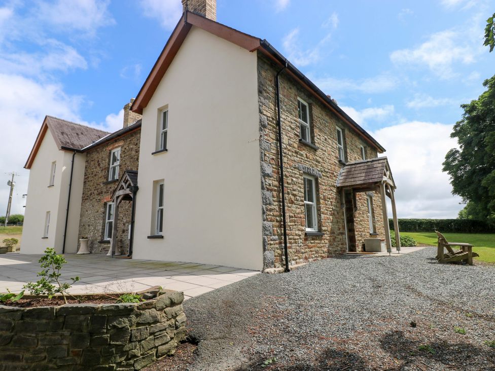 A house with stone exterior and patio area at The Sycamores in Llawhaden near Narberth