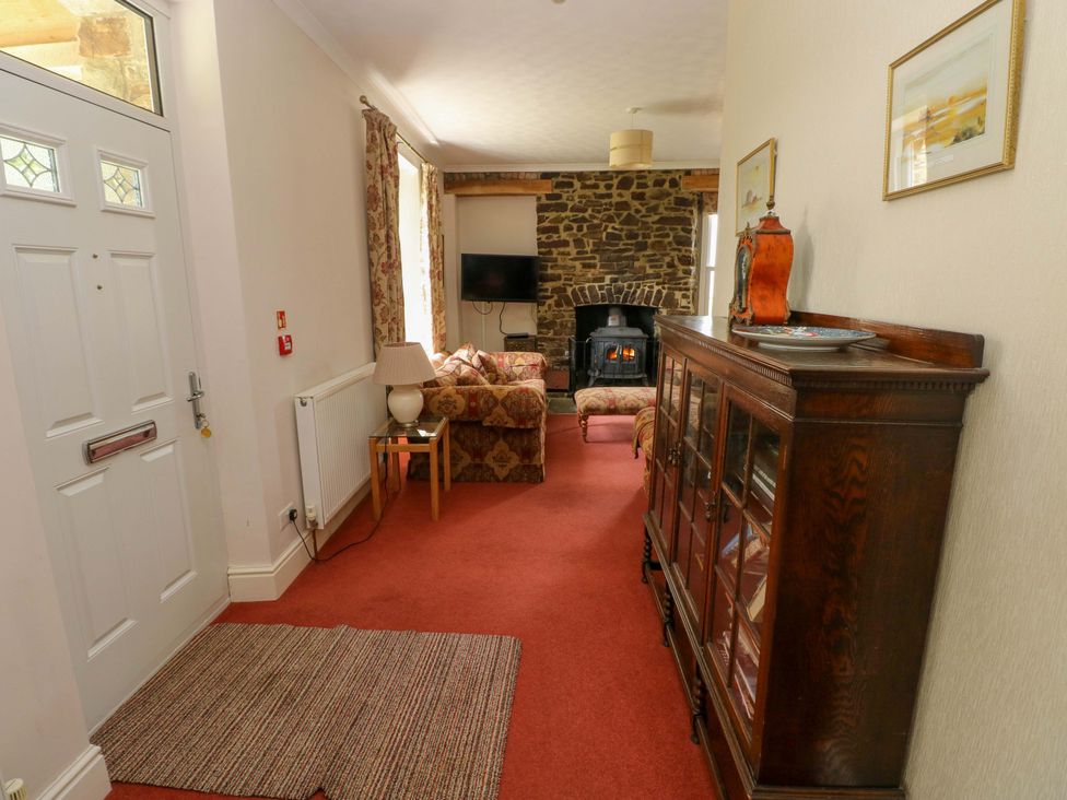 A living room with a sofa and television at The Sycamores in Llawhaden near Narberth
