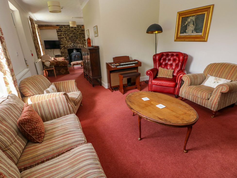 A living room with sofas and a coffee table at The Sycamores in Llawhaden near Narberth