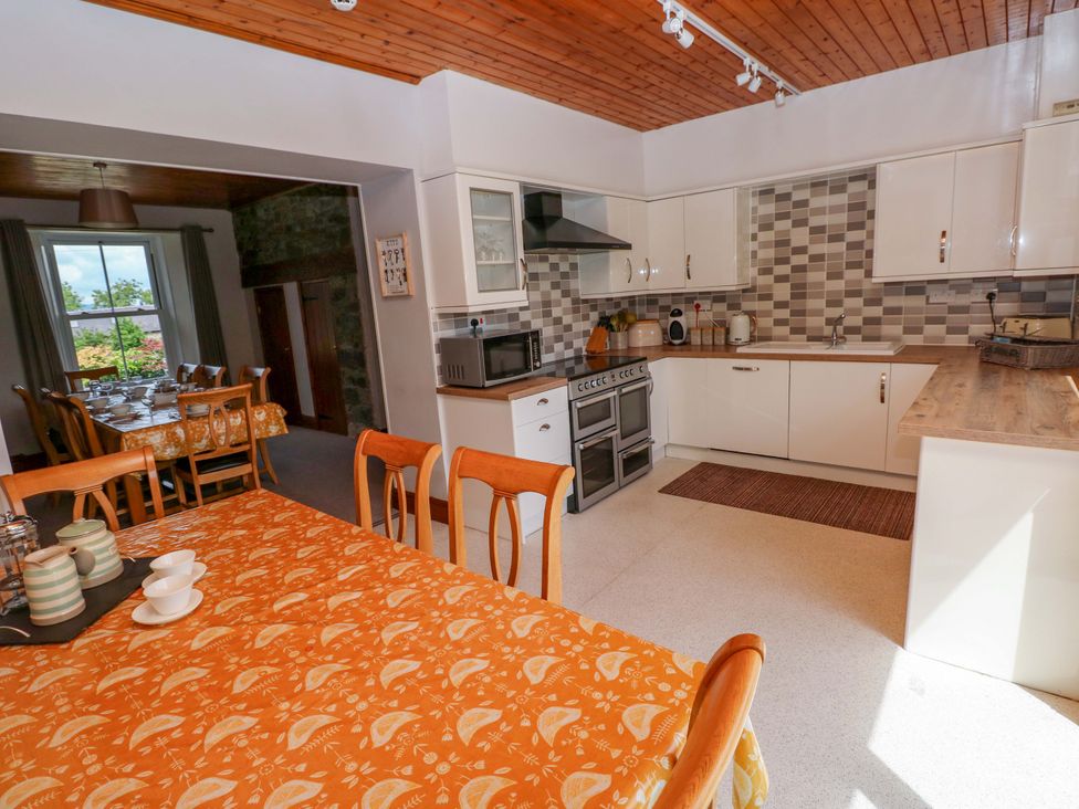 A kitchen with a table and chairs at The Sycamores in Llawhaden near Narberth