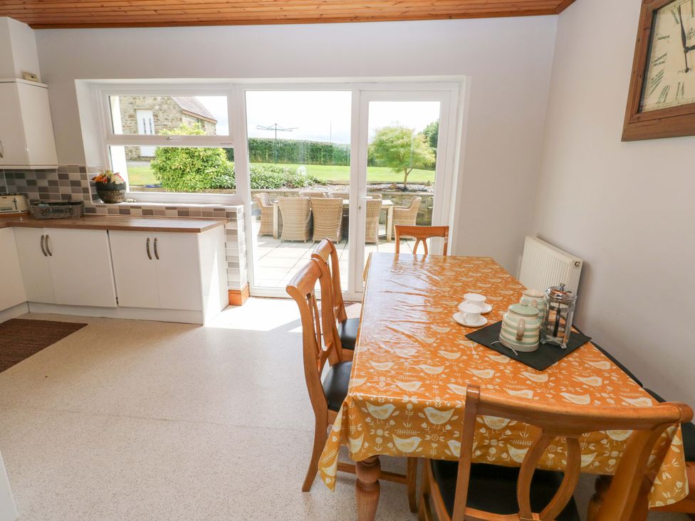 A dining room with a table and chairs at The Sycamores in Llawhaden near Narberth
