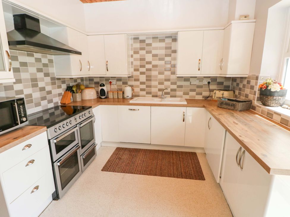 A kitchen with cabinets and appliances at The Sycamores Llawhaden near Narberth