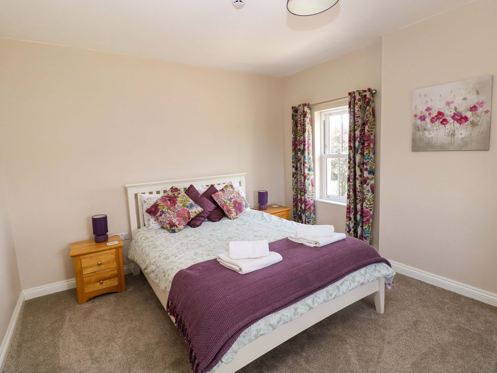 A bedroom with a bed and bedside table at The Sycamores Llawhaden near Narberth