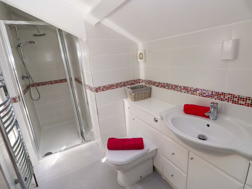 A bathroom with a shower, toilet, and sink at The Sycamores in Llawhaden near Narberth
