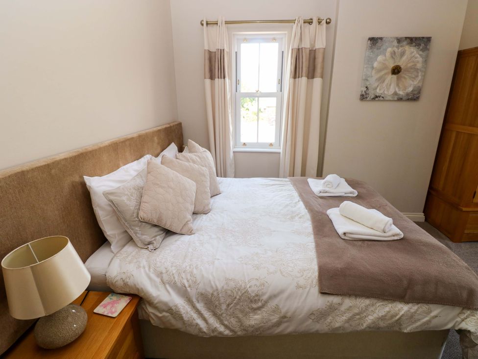 A bedroom with a bed and window at The Sycamores in Llawhaden near Narberth