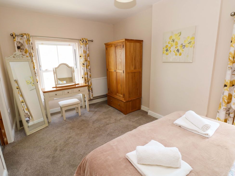 A bedroom with a dressing table and mirror at The Sycamores in Llawhaden near Narberth